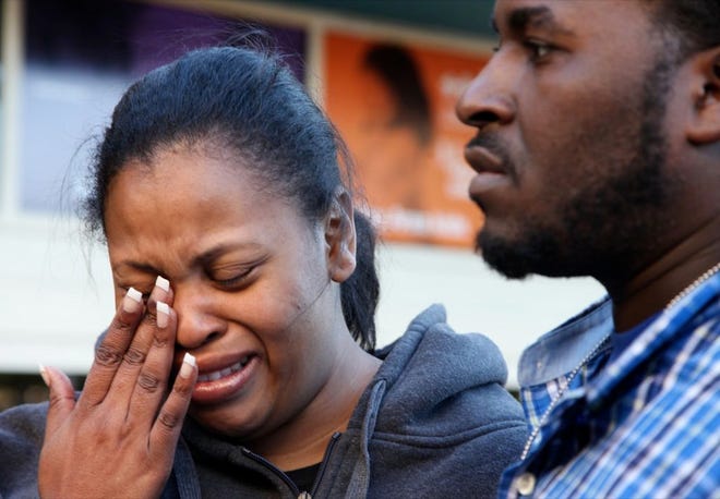 In this Dec. 16, 2013 photo, Nailah Winkfield, mother of Jahi McMath, wipes her face while speaking to reporters with her husband Martin Winkfield in front of Children's Hospital Oakland in Oakland, Calif. McMath remains on life support at Children's Hospital Oakland nearly a week after doctors declared her brain dead. (AP Photo/Bay Area News Group, Laura A. Oda)