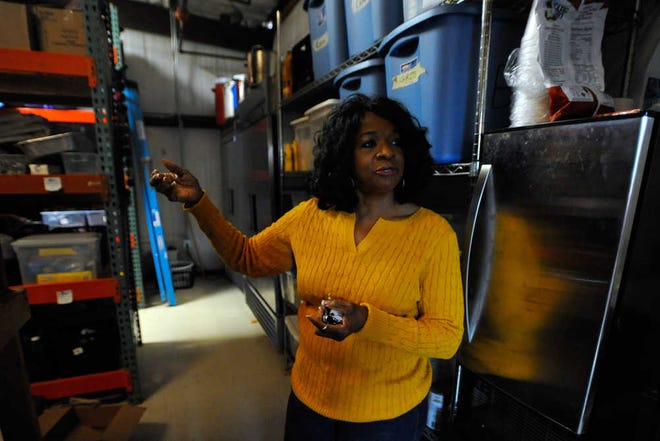Alzena Johnson gives a tour of the storage room and freezer at Bigger Vision Community Shelter in Athens, Ga., Friday, Dec. 20, 2013. (AJ Reynolds/Staff, @ajreynoldsphoto)