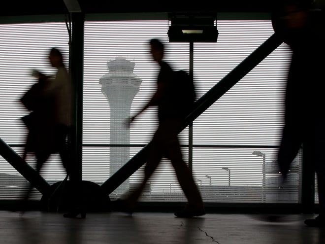 Passengers walk through Terminal 3 at O'Hare International Airport in Chicago on Saturday, Dec. 21, 2013. The National Weather Service this morning issued a hazardous weather outlook for north central Illinois, northeast Illinois and northwest Indiana.