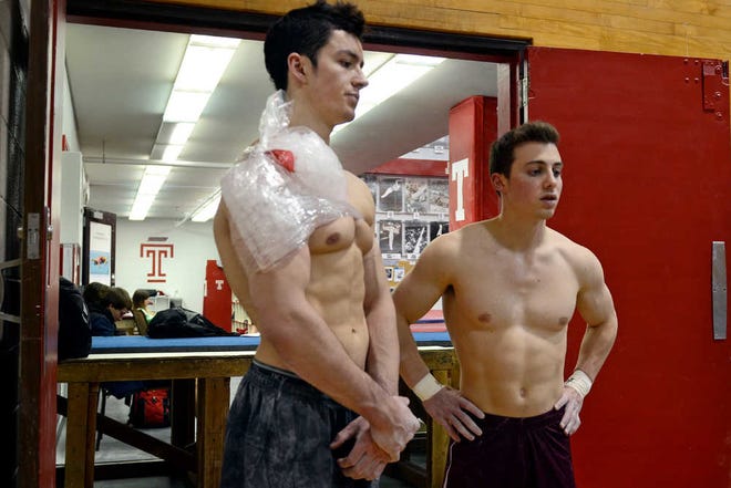 In this Dec. 6, 2013, photo, Temple men's gymnastics junior Colton Howard, left, and sophomore Evan Eigner pause after working out at the university, in Philadelphia. In early December, Temple announced that it is eliminating seven of its 24 sports, including men's gymnastics, effective in the fall. "When I heard the news, I kind of went numb a little bit," Eigner said. (AP Photo/The Philadelphia Inquirer, Tom Gralish) TV OUT MAGS OUT