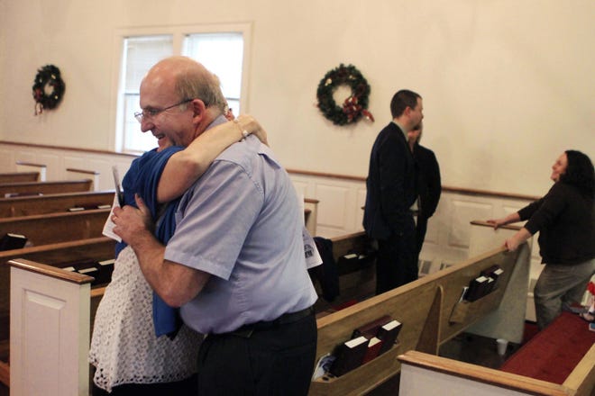 Kevin Mansfield, the new pastor at Shannock Baptist Church in Charlestown, gets a hug from Sandy Anderson, of Richmond, before the service Sunday.