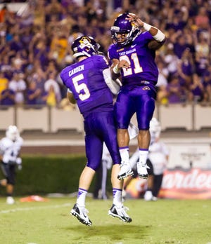 ECU’s Shane Carden (5) and Vintavious Cooper (21) celebrate a touchdown against Old Dominion earlier this season. The Pirates square off with Ohio on Monday at 2 p.m. in the Beef ‘O’ Brady’s Bowl in St. Petersburg, Fla.