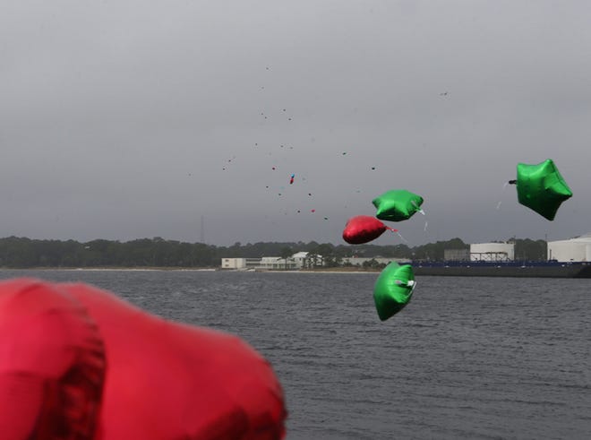 Balloons are released in the name of loved ones at the Panama City Marina in Panama City on Sunday, December 22, 2013.at the Panama City Marina in Panama City on Sunday.