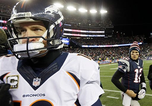 Denver Broncos quarterback Peyton Manning (18) heads toward the locker room after shaking hands with New England Patriots quarterback Tom Brady (12) after losing in overtime of an NFL football game, Monday, Nov. 25, 2013, in Foxborough, Mass. The Patriots defeated the Broncos 34-31.