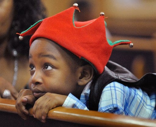 Derrius Hall, Jr., 5, attended the Operation Save Our Sons event at St. Paul Church with his grandmother Terrell Felton Monday, December 23, 2013 in Jacksonville, Florida.