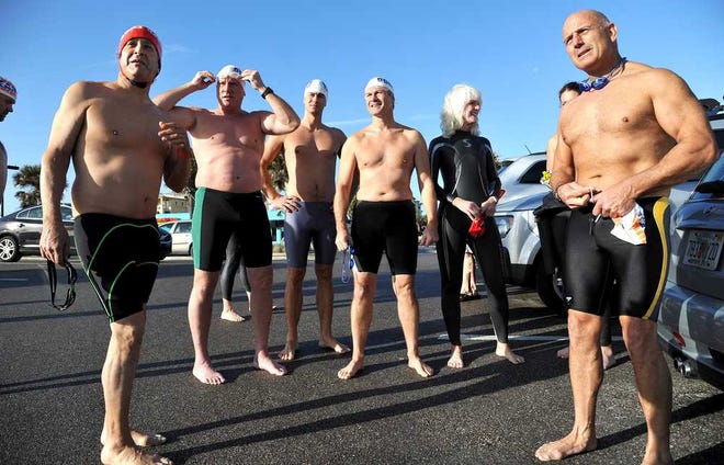 Photos by Bruce.Lipsky@jacksonville.com Richard Shieldhouse (left) and Luis Etchenique (right) get ready to hit the surf with other open-water swimmers Sunday. The Duval Ocean Swimmers met near the Jacksonville Beach Fishing pier for a brisk swim to 20th Avenue North.
