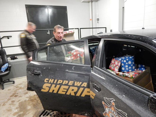 SCOTT BRAND/ The Evening News
Chippewa County Sheriff Robert Savoie loads his vehicle with presents and food early this morning in preparation for a special delivery later today. The Chippewa County Sheriff Office annually selects a worthy family delivering a memorable Christmas for the lucky recipients.