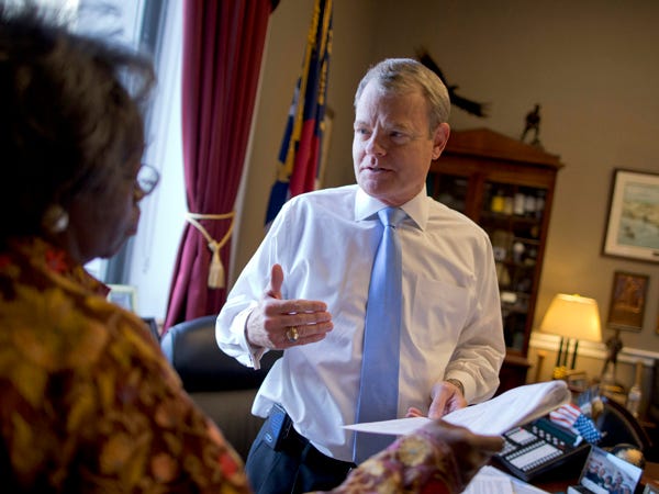 Rep. Mike McIntyre, D-N.C., speaks with his chief of constituent services, Vivian Lipford, in his office on Capitol Hill in Washington. Photo by Associated Press
