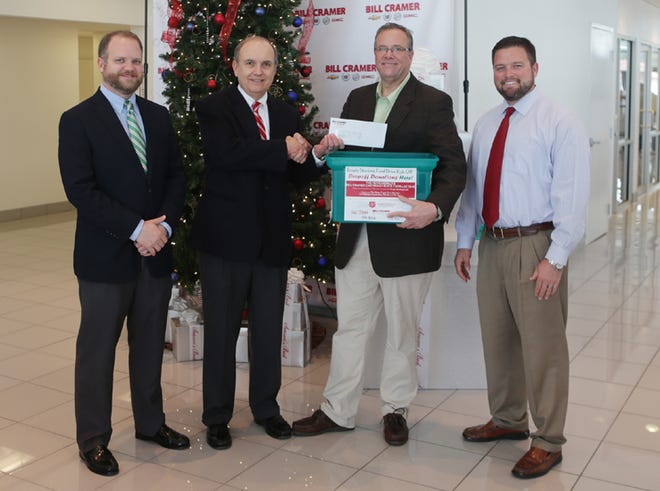 From left to right: Will Cramer, Bill Cramer, Mike Cazalas and Chris Cramer celebrate another successful Empty Stocking Fund campaign.