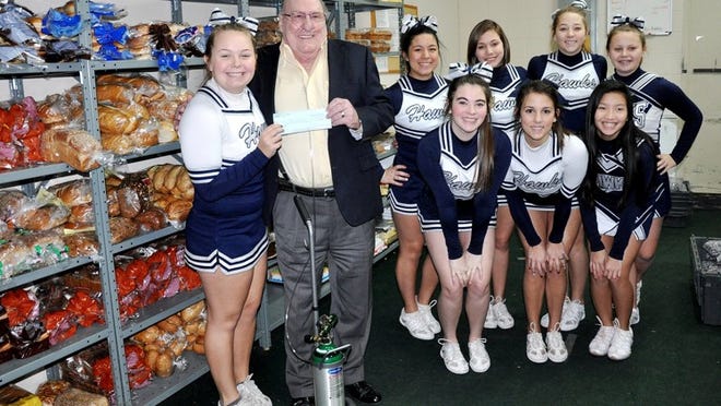 Members of the Hendrickson Hawk Cheer Team presented a $500 donation to The Storehouse Food Mission on Saturday, Dec. 14. The donation represents a portion of the funds raised through the annual Tiara 5K, sponsored by the HHS Spirit Boosters. Accepting the check on behalf of The Storehouse is CEO Jack Cochrun. Representing the HHS cheer team are: Michelle King (presenting check); front row: Briley Richards, team captain Jessica Hancock and Victoria Hoang; (back row): Kiana Wheeler, Katie Triebes, Taylor Jund and Lauren King.