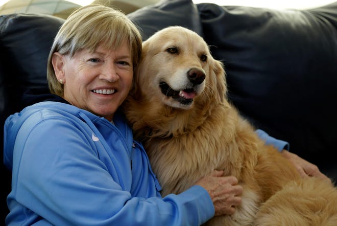 North Carolina women's basketball coach and Gastonia native Sylvia Hatchell sits with her dog, Maddie, in Chapel Hill on Dec. 18. After being diagnosed with leukemia, Hatchell has temporarily stepped away from her coaching duties to focus on treatment.