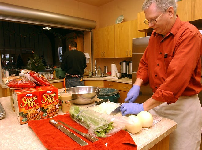 Curtis Neuner cuts up onions and celery Tuesday for a Christmas dinner hosted by First Presbyterian Church in Corning.