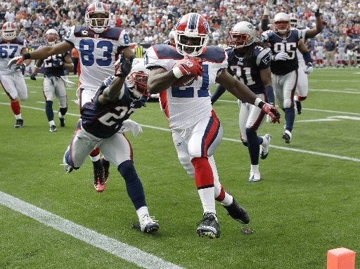 Buffalo Bills running back C.J. Spiller scrambles past New England Patriots cornerback Kyle Arrington, left, for a touchdown during the first half of an NFL football game in Foxborough, Mass., Sunday, Sept. 26, 2010.