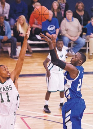 DCCC's C.J. Woodberry shoots a jump shot over GTCC's Keith Jackson in a game earlier this season.