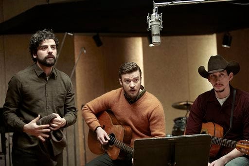 FILE - This file film image released by CBS FIlms shows, from left, Oscar Isaac, Justin Timberlake and Adam Driver in a scene from "Inside Llewyn Davis." In the Coen brothers film, Timberlake plays a supporting role as a cheery, sweater-wearing 1960s folk musician. But he also collaborated with producer T Bone Burnett on the movieís memorable period songs and helped shape the filmís most unforgettable and comic tune, Please Mr. Kennedy. (AP Photo/CBS FIlms, Alison Rosa, File)
