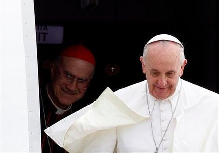 Pope Francis, followed by Vatican Secretary of State Cardinal Tarcisio Bertone, disembarks from the plane after landing from Rio de Janeiro, Brazil, at Ciampino's military airport, on the outskirts of Rome, Monday, July 29, 2013. The pontiff returned after a week in Brazil.