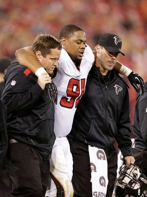 Atlanta Falcons defensive tackle Corey Peters (91) is helped off the field during the first half of an NFL football game against the San Francisco 49ers in San Francisco, Monday, Dec. 23, 2013. (AP Photo/Tony Avelar)