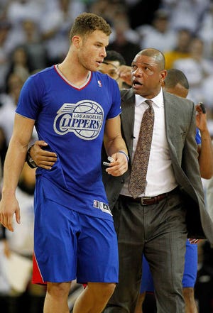 Los Angeles Clippers head coach Doc Rivers, right, walks forward Blake Griffin, left, off the court after he was ejected for his second technical foul against the Golden State Warriors during the second half in a NBA basketball game, Wednesday, Dec. 25, 2013, in Oakland, Calif. Warriors won 105-103.(AP Photo/Tony Avelar)