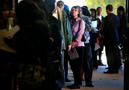 FILE - In this Nov. 7, 2013 file photo, Jona Caldwell joins a long line of job seekers outside the Ferguson Community Center in Cordova, Tenn. The Labor Department reports on the number of Americans who applied for unemployment benefits in the last week on Dec. 26, 2013.
