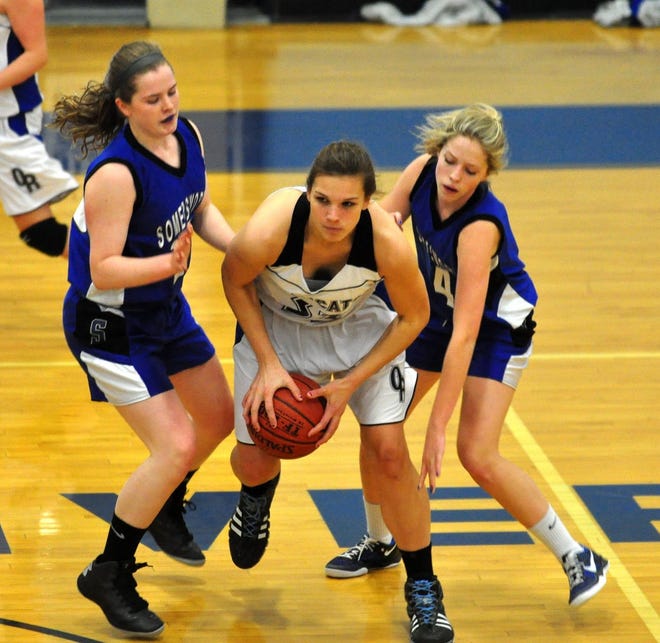 Whaley/Democrat photo

Oyster River's Claire Salmon, center, is defended by Somersworth's Becca Laurion, left, and Emily Francoeur during the Bobcat Invitational Thursday in Durham.