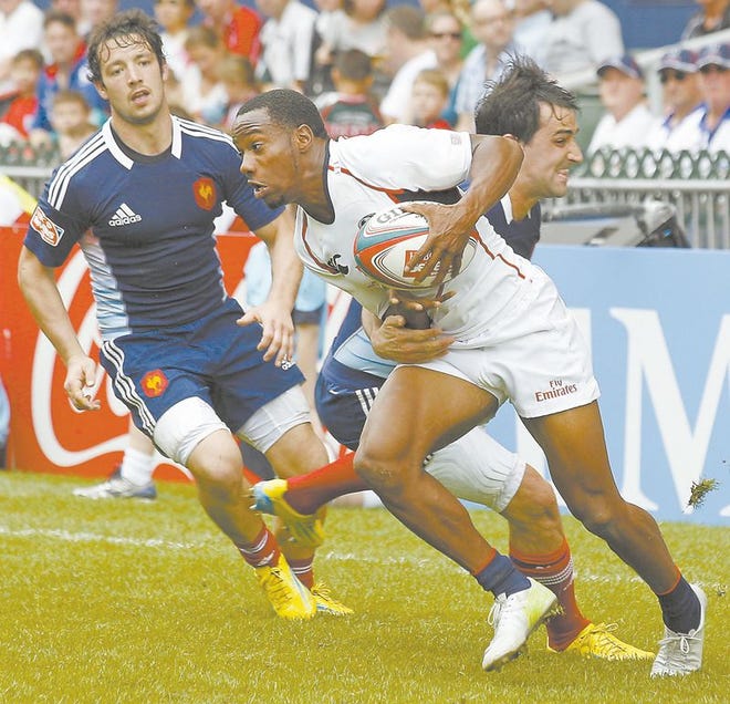 Carlin Isles of the Unietd States is tackled by Vincent Inigo (right) and Paul Albaladejo, of France, during the day 2 match of the Hong Kong Sevens rugby tournament in Hong Kong last March. Isles, a former Jackson High School standout, has signed an NFL contract with the Detroit Lions' practice squad.
He is projected to be a wide receiver on the practice squad in Detroit. 
Isles hadn't played football since he graduated from Ashland University
