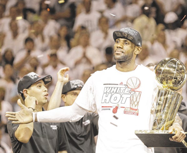 The Miami Heat's LeBron James holds the the Larry O'Brien NBA Championship Trophy after winning the NBA title last June. James has been named the AP Athlete of the Year.