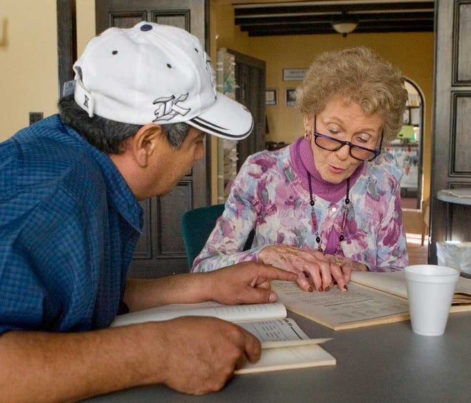 Alice Soper, a volunteer tutor and coordinator of the English for the Foreign Born tutorial program at Washburn University's International House, helps Topeka resident Hugo Martinez improve his English skills during a recent lesson.