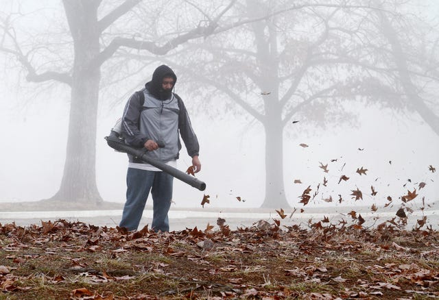 RACHEL RODEMANN • TIMES RECORD / Jose Mendez blows leaves from the parking lot at Hardscrabble Country Club in Fort Smith in a freezing fog, Thursday, Dec. 26, 2013.