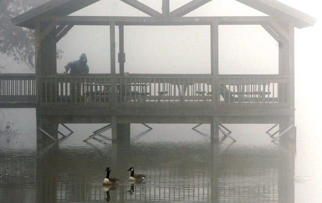 BRIAN D. SANDERFORD • TIMES RECORD / Canada geese glide by a fisherman on the pier at fog-covered Wells Lake on Thursday at the Janet Huckabee Arkansas River Valley Nature Center. Sunny weather is expected for today with highs in the upper 50s. 
 BRIAN D. SANDERFORD • TIMES RECORD / Canada geese glide by a fisherman on the pier at fog-covered Wells Lake on Thursday at the Janet Huckabee Arkansas River Valley Nature Center. Sunny weather is expected for today with highs in the upper 50s.