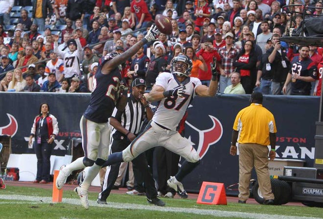 Denver Broncos wide receiver Eric Decker (87) catches a touchdown pass as Houston Texans cornerback Kareem Jackson (25) defends during the second half of an NFL football game on Sunday, Dec. 22, 2013, in Houston. (AP Photo/The Courier, Jason Fochtman)