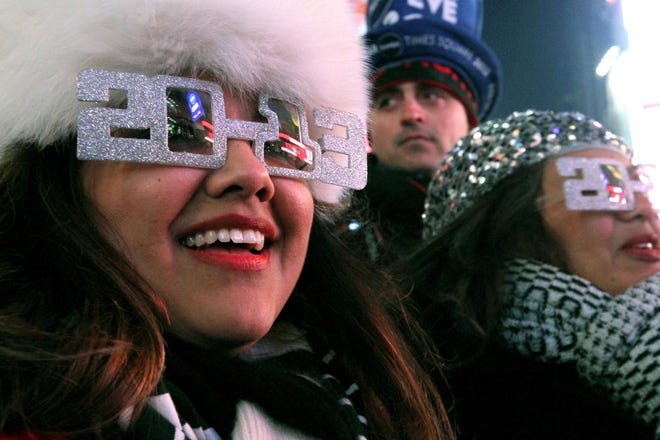 Alexandra Esquivel, left, and her aunt Anna Ramos, right, both from Arizona, attend the New Year’s Eve festivities Dec. 31 in New York’s Times Square. This year, most Americans — 54 percent — say they’ll be ringing in the new year at home, while 1 in 5 are heading to a friend’s or family member’s house.