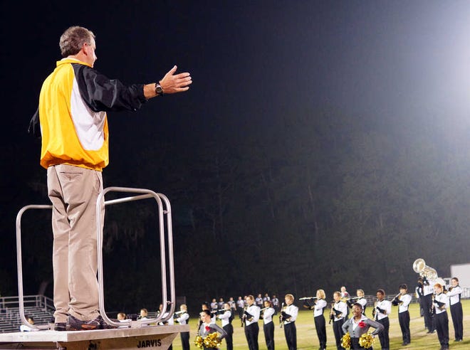 Daniel Kiene conducts the Marching Wildcats' performance of the national anthem before Richmond Hill's playoff game on Nov. 15.