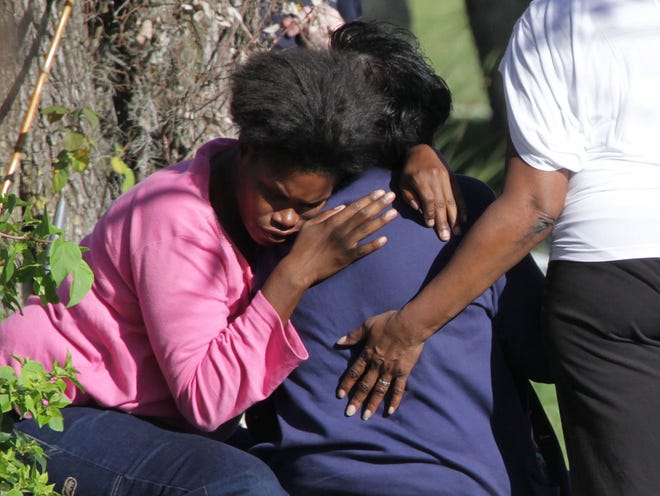 Talisa Brown hugs her mother Lillian Brown after learning that her 2-year-old son had passed away at Halifax Health Medical Center. The 2-year-old boy drowned in a pond behind the family's house on Aleatha Drive in Daytona Beach Monday afternoon.
