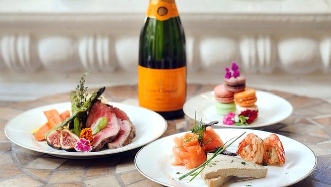 C’est Si Bon’s dinner for two includes beef tenderloin with vegetables, Veuve Clicquot Champagne, smoked salmon, duck-liver paté, shrimp and ‘macarons.’