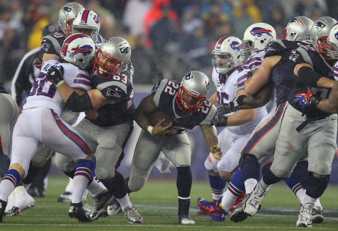 Patriot running back Stevan Ridley squeezes through an opening during the first half of Sunday’s regular-season finale against the Buffalo Bills at Gillette Stadium.