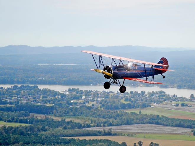 A 1929 Curtiss- Wright Travel Air biplane piloted by David Mars carrying Donny Harrison and Penny McClain files over Southside while giving rides from Northeast Alabama Airport in Gadsden on October 21, 2013.