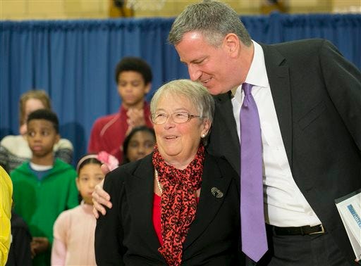 Carmen Farina is embraced by Mayor-elect Bill de Blasio Monday after he introduced her as the next New York City schools chancellor in Brooklyn. De Blasio takes office on Jan. 1.