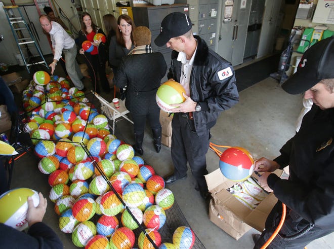 Representatives from Simon Property Group across the country inflate 10,000 beach balls to prepare for New Year's Eve on Monday.