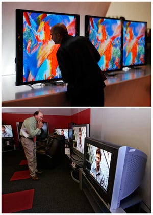 In this combination of file photos, a man, top, looks at the back of a Sony 4K XBR LED television in Las Vegas and, bottom, a man looks at a CRT television in Redwood City, Calif. Some 40-inch LED televisions bought in 2013 use 80 percent less power than the cathode ray tube televisions of the past. Some use just $8 worth of electricity over a year when used five hours a day.