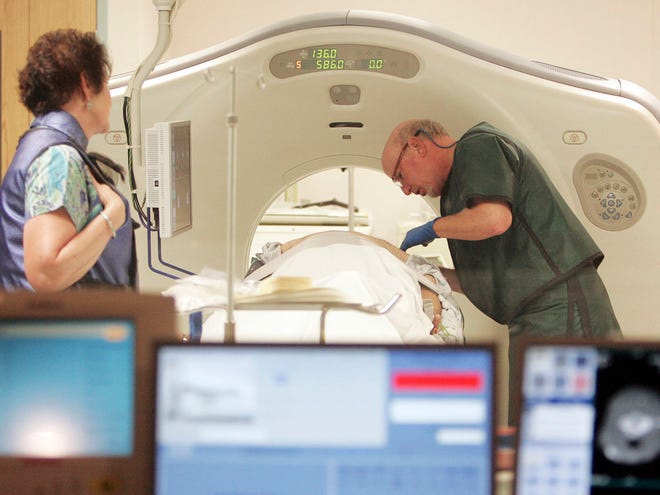 In this June 3, 2010, file photo, Dr. Steven Birnbaum works with a patient in a CT scanner at Southern New Hampshire Medical Center in Nashua, N.H.