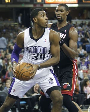 Kings forward Jason Thompson (34) posts up against the Heat's Chris Bosh during Friday's overtime victory over Miami.