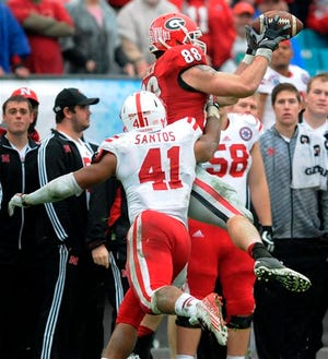 Georgia's Arthur Lynch, (88) is tackled by Nebraska's David Santos (41) after a reception during the Gator Bowl NCAA college football game Wednesday, Jan. 1, 2014, in Jacksonville, Fla. (AP Photo/The Florida Times-Union, Kelly Jordan) MAGS OUT TV OUT
