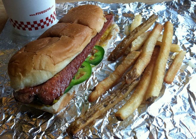 Five Guys' hot dogs are sliced lengthwise and served with any of 18 toppings.