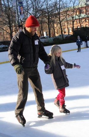 Casey Dunn and his daughter, Lucy, 7, enjoy some Christmas Eve skating.