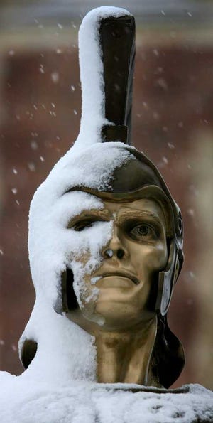 In this February 2013 file photo, the Trojan mascot stands covered in snow at Topeka High School after a winter storm passed through Topeka. Despite the storm, 2013 recorded temperatures and precipitation that were near "the middle of the pack."