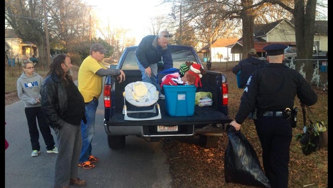 Bessemer City Fire Chief Jamie Ramsey with his family, along with Bessemer City Police officers, help unload donations given to the Roberts family after their home was destroyed by a fire the day after Christmas.