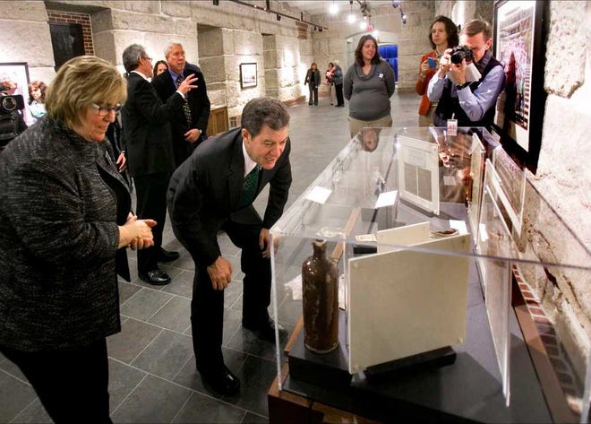 After cutting the ribbon to officially open the Capitol visitor center Thursday morning, Gov. Sam Brownback took a tour of the exhibits, including this one showing some of the artifacts that were found during the Statehouse renovation.