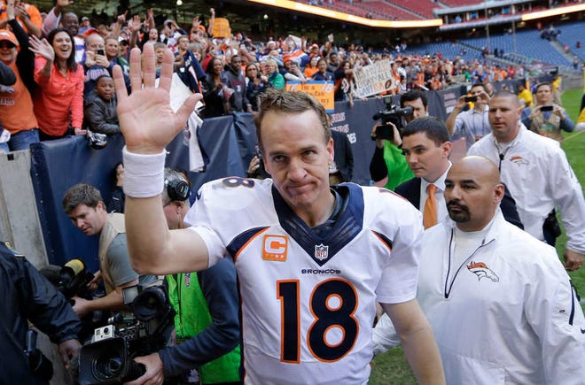 FILE - In this Dec. 22, 2013 file photo, Denver Broncos' Peyton Manning (18) waves to fans following an NFL football game against the Houston Texans in Houston. Manning threw his 51st touchdown pass of the season to set a new NFL record. Manning was the only unanimous choice for the 2013 Associated Press NFL All-Pro team Friday, Jan 3, 2014. It was his seventh time as a first-teamer, tying Hall of Famer Otto Graham for the most by a quarterback. (AP Photo/David J. Phillip)