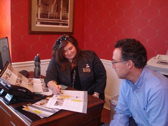 Realtor Christine M. Aust discusses home warranties in her Yardley office.