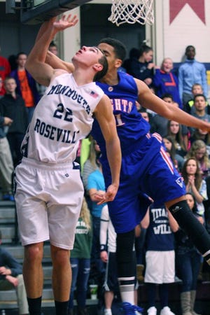 Monmouth-Roseville’s Dalton Hottle battles along the boards during Friday night’s victory over Peoria Heights. Hottle scored 8 points. With the win, the Titans improved to 12-1 on the season. RUTH KENNEY/REVIEW ATLAS